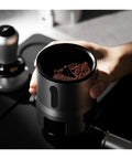 Espresso Gang Verified Shaker Funnel With Built In Dosing Cup For 58mm Portafilter showing coffee grounds in hand-held funnel.