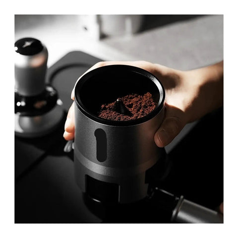 Espresso Gang Verified Shaker Funnel With Built In Dosing Cup For 58mm Portafilter showing coffee grounds in hand-held funnel.