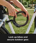 Person holding Set Your Own Four Digit Combination Bike Lock With Braided Steel Cable And Weather Resistant Vinyl Coating