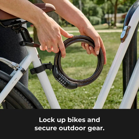 Person holding Set Your Own Four Digit Combination Bike Lock With Braided Steel Cable And Weather Resistant Vinyl Coating