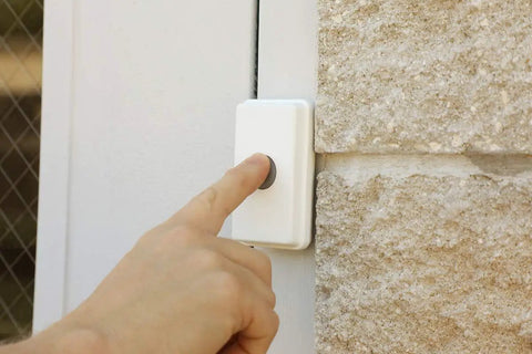 Hand pressing button on Wireless Warehouse Doorbell Kit With Flashing Strobe For Noisy Industrial And Residential Environments Loud Entry Alert