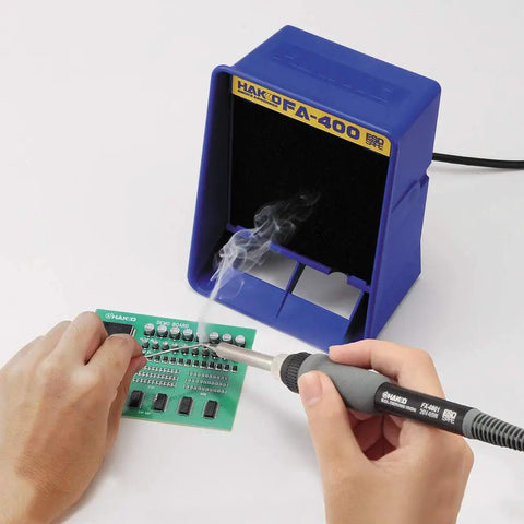 Person using Lightweight Soldering Iron With T18-B Tip For Electronics, 26V 65W Ceramic Heater on PCB with smoke absorber