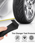 4 Pack Tire Changer Jaw Protectors Black Clamp Covers For Wheel Demount Machines Rim Safety Guards held next to car tire.