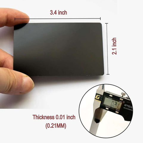 Person holding Fifty Pcs Matte Black Metal Business Card Blanks For Laser Engraving, showing size 86 x 54 mm, 0.21 mm thickness.