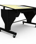 Electric Sewing Table With Rock Solid Height Adjustments And Smooth Tilt Remote Control Craft Desk For Makers Includes Heavy Duty Cutting Mat Plus Sharp Rotary Cutter Workstation Black side view of motorized craft desk on wheels