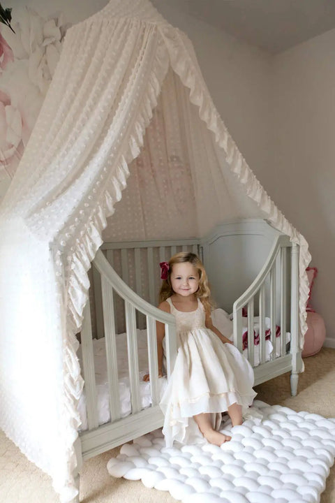 Tot Friendly Cozy Kids Bed Canopy With Lace Chiffon Netting And Pom Poms Dreamy Princess Fairy Tent installed on a crib