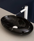 Top Tier Ceramic Vessel Sink For Master Bathroom Vanity Countertops, Badass Artistic Wash Basin With Waterproof Glazed Finish And Hella Easy Wipe Down Cleaning Routine, black ceramic oval shape with white veins and faucet.