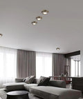 Ten Pack Brushed Brass Led Downlights Featuring Dimmable Eyeball Retrofit Spotlights illuminating a modern living room ceiling.