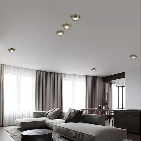 Ten Pack Brushed Brass Led Downlights Featuring Dimmable Eyeball Retrofit Spotlights illuminating a modern living room ceiling.