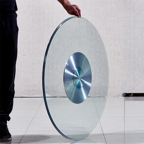 Person holding 30 Inch Kitchen Tabletop Lazy Susan Turntable With Tempered Glass 360 Degree Swivel Serving Tray Aluminum Base.