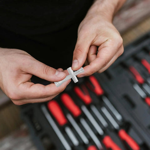 Close-up of hands holding Mini Cross Socket Wrench Kit M2 M2.5 M3 for RC Model Cars, silver alloy material.