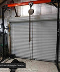 Bad Boy Heavy Weight One Ton Gantry Crane Frame Rated For Two Thousand Pounds adjustable hoist rig with pulley in workshop setting.