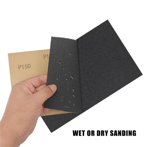 Kick Your DIY Projects Into High Gear With 60 Pcs Assorted Grit Sandpaper Sheets Perfect For Wet And Dry Sanding Polishing Wood Metal And Auto Surfaces To Get That Smooth Finish, hand holding wet and dry sandpaper sheets.