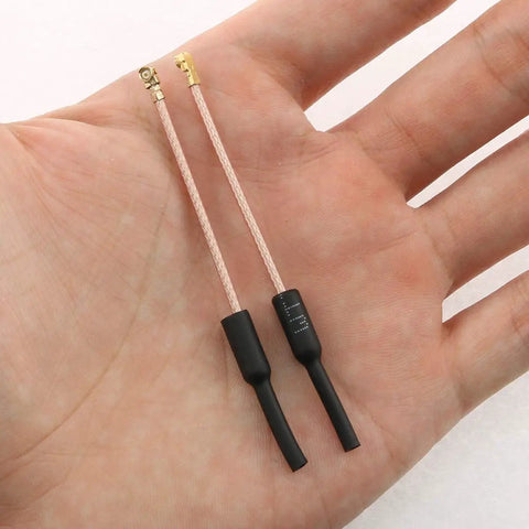 Hand holding Dual Pack Seven Centimeter Five Point Eight Gigahertz FPV Antenna Set For RC Drones IPEX Connector Lightweight Flexible Cable