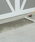 Applying Heavy Duty Clear Acrylic Concrete Sealer For Driveways And Patios Fast Drying Waterproof Sealant For Stone And Exposed Aggregate Surfaces 4.75 Gallon Jug Size with a roller.