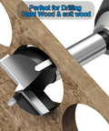 Front view of a carbide-tipped 3-inch Forstner drill bit cutting a hole in plywood.