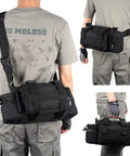 Person carrying a Bike Handlebar Bag With 900D Nylon Water Resistant Tactical Waist Pack For Cycling And Hiking, black, with MOLLE system.