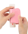 Hands holding a Six Hole Punch For Loose Leaf Paper A4 A5 B5 Portable Handheld Metal Circle Puncher 5 Sheet Capacity Pink
