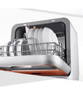 Hassle Free Plug And Play Slick Countertop Dishwasher Fully Automatic Mini Desktop Cleaner with dishes inside.