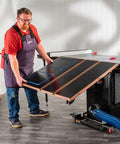 Person adjusting Folding Table Saw Outfeed Kit With Adjustable Height Legs And Foldable Steel Frame For Easy Storage.