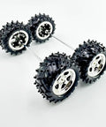 4 Pack RC Car Wheels With Metal Shafts Fits 3mm Axles, shown with plastic tire tread design, durable and easy to install