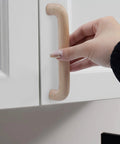 Installing a Beech Wood Drawer Pulls Unfinished Cabinet Handles For Kitchen Cupboards Dresser Wardrobes And Closets on a white cabinet