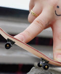 Finger performing tricks with a maple wood fingerboard, part of the 8 Pack Mini Fingerboard Set Maple Wood With Plastic Case Tiny Skateboards.
