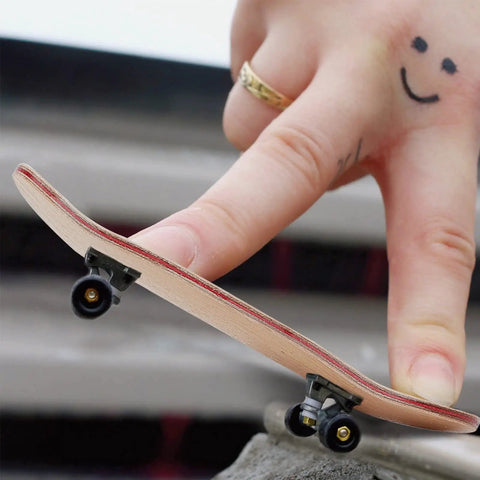 Finger performing tricks with a maple wood fingerboard, part of the 8 Pack Mini Fingerboard Set Maple Wood With Plastic Case Tiny Skateboards.