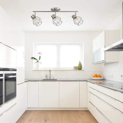 Cedrick 3 Light Track Lighting in Brushed Nickel, adjustable heads, vintage Edison bulbs, installed in modern white kitchen