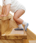 Child on wooden stairs with Clear No Slip Stair Treads 6 By 30 Inches 15 Pack Pre Cut For Wooden Indoor Steps Waterproof Grip Tape