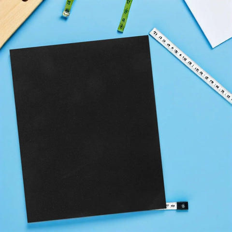 Get This Ultimate 20 Piece Wet Sanding Paper Assortment With Super Fine Grit Sheets For Smooth Results On Any DIY Or Pro Job Without Clogging A sheet of waterproof sandpaper on a blue background with measuring tapes.