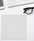 Top Shelf Reusable White Microfiber Cleaning Cloth For Eyeglasses And Camera Lenses Ultrafine Cleanroom Grade Polish on a desk with glasses and smartphone.