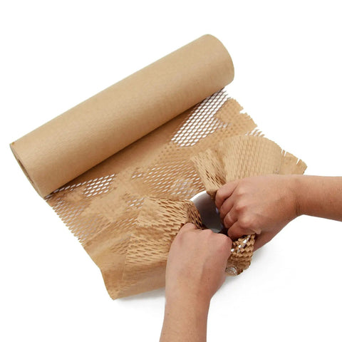 Top Tier Honeycomb Packing Paper Bubble Wrap Alternative For Moving Supplies Stretchy Kraft Cushion Roll being unrolled and used.