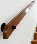 Built Tough Wall Mount Wood Handrail With Industrial Pipe Brackets For Indoor Staircases Hallways And Landings smooth surface close-up against wall.