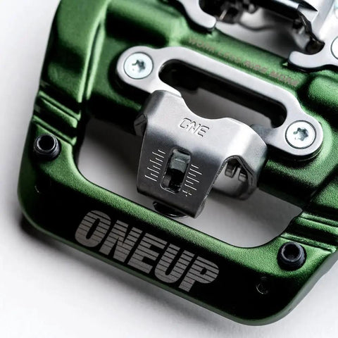 Close-up of a green Ultra Thin Mountain Bike Clip Pedals Orange With Extra Large DH Sized Platform 26.8mm Profile For Maximum Grip And Fewer Pedal Strikes Lightweight Bombproof Clip In Pedals with ONEUP branding.