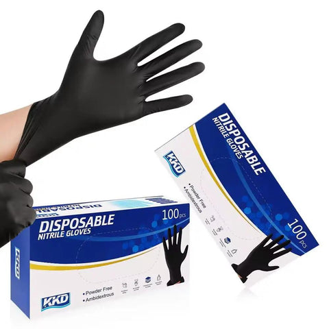 Person putting on Heavy Duty Black Nitrile Gloves 100 Count Medium Disposable Latex And Powder Free Thick Ribbed Cuffs For Kitchen Cooking Cleaning And Industrial Tasks Built Tough And Ready For The Daily Grind.