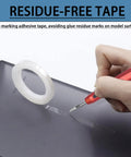 Close-up of Premium Tungsten Steel Model Scriber Blades Pair cutting residue-free tape on black model surface.
