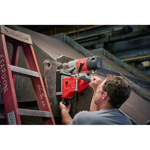 1-5/8 Inch Corded Magnetic Drill Kit With Variable Speed Control in use, drilling on steel at fabrication site.