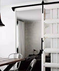 Sliding Barn Door Pull Handle Set With Flush Hardware In Rustic Black Powder Coat Finish on installed white sliding door