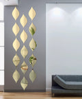 Teardrop Mirror Stickers 15 Pack Gold Wavy Acrylic Removable Wall Decals in living room, modern teardrop shaped design.