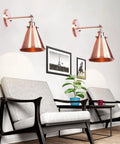 Heavy Duty Adjustable Wall Sconce Featuring Straight Up Industrial Design Foolproof Mounting E27 Base Solid Bronze Glow Ideal For Reading Lounge Bath Or Guest Room In Rich Red Tone with copper finish above modern seating.