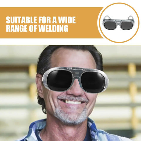 Heavy Duty Welding Goggles With Anti Fog Black Grey Lens No Sweat Dust Splash Shield Rock Hard Industrial Eye Protection Gear Shop Tough For Arc Gas Welding Pros And Fabricators worn by worker smiling in industrial setting.