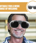 Heavy Hitter Welding Goggles With Black And Gray Tinted Lenses, Zero Fuss Splash And Dust Resistant worn by smiling man.