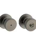 Two gunmetal interior round privacy doorknobs with lock; front-face hole and interior turn-button view.