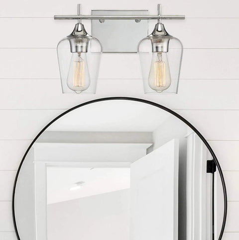 Dope Octave Bohemian Clear Glass Vanity Wall Light Two Light Bath Fixture in warm brass above a round bathroom mirror