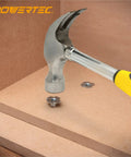 Hammer striking Heavy Duty Zinc Plated Tee Nuts 1/4 20 Thread 50 Pack For Woodworking Furniture Builds in wood.