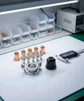 Tough As Nails 12 Piece Plasma Torch Parts Kit Featuring Copper Alignment Nozzles and Secure Socket Electrodes on a worktable.
