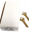 Box of SC4 BR Brass Key Blank For SCH C 6 Pin Keyway, 50 pack, with two brass key blanks lying beside it.