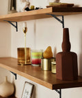 Floating shelves supported by 8 Piece L Shaped Metal Shelf Brackets, heavy duty iron with rust resistant finish, installed with decor items.