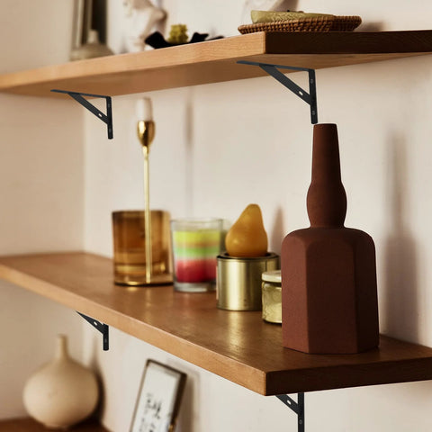 Floating shelves supported by 8 Piece L Shaped Metal Shelf Brackets, heavy duty iron with rust resistant finish, installed with decor items.